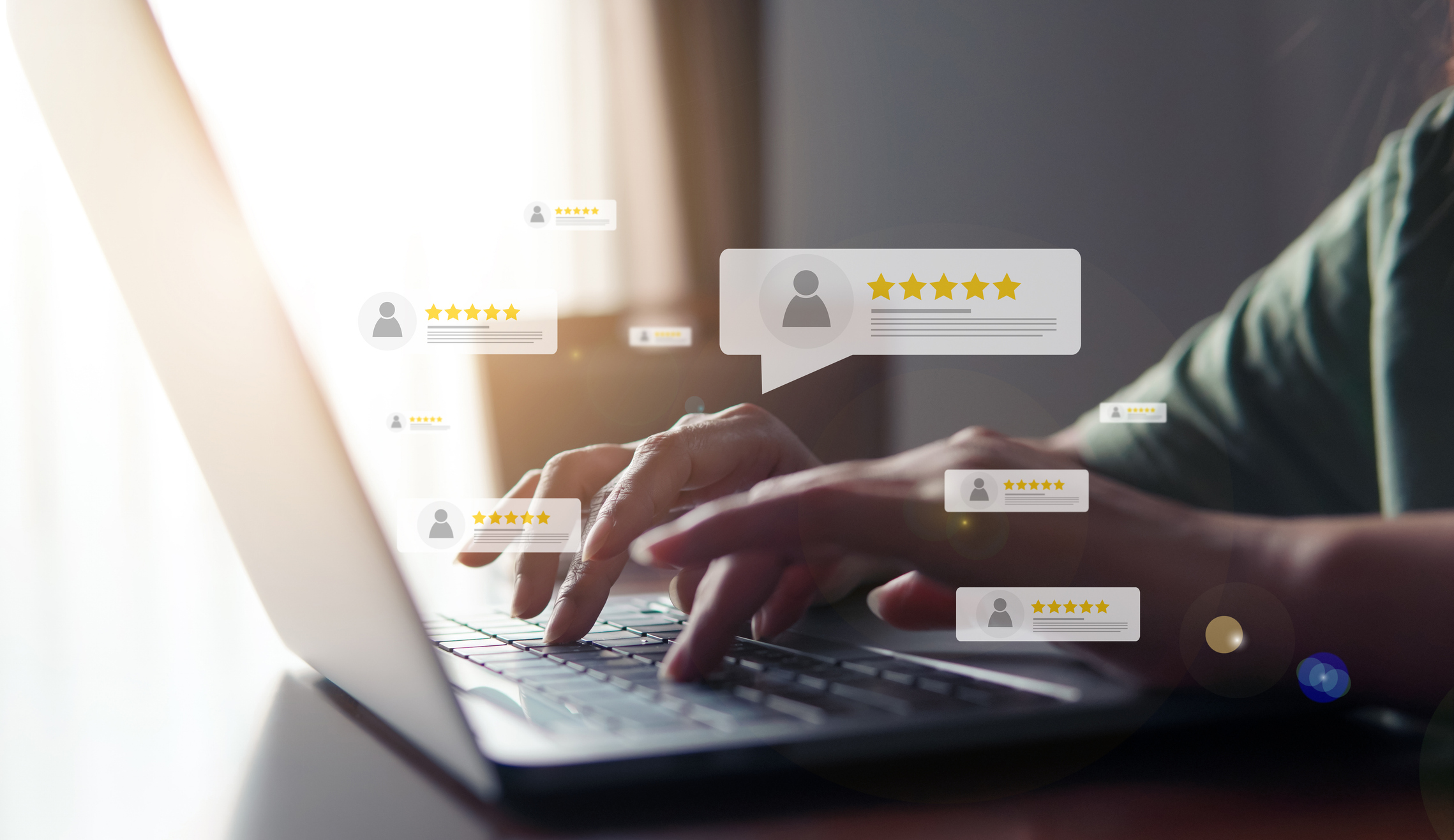 Stock image of a person's hands typing on a laptop with overlaid graphics of 5-star reviews on top.