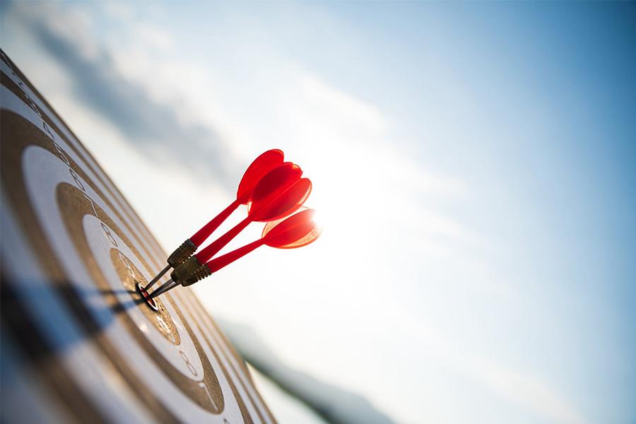 stock image of a dart board with three darts in the bullseye
